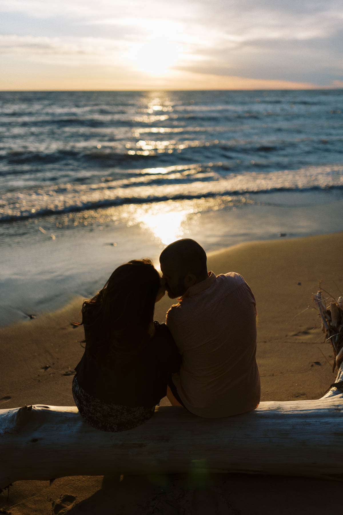 engagement session at sunset on the beach - a kiss