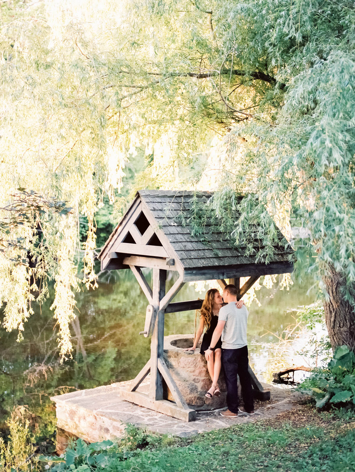 engagement session at scotsdale farm, with couple embracing on the well