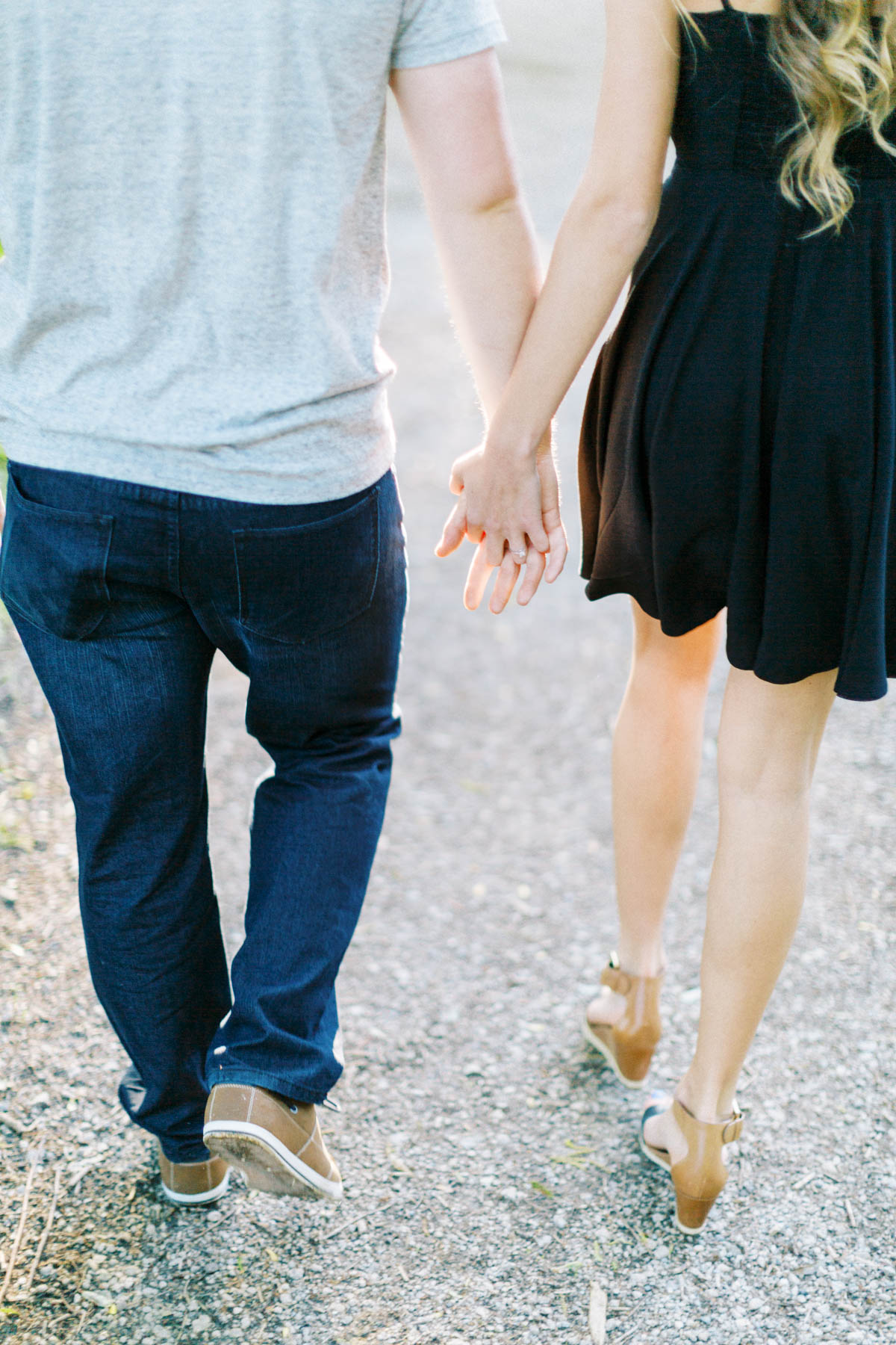 couple holding hands while they walk a path at scotsdale farm