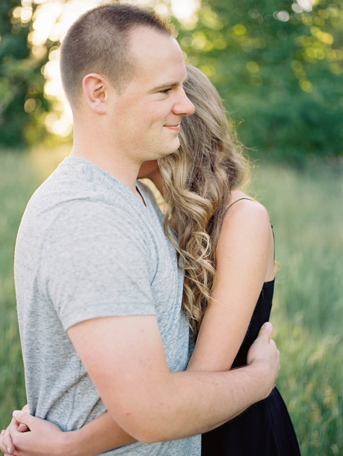 smiling and hugging during an engagement photography session at scotsdale farm